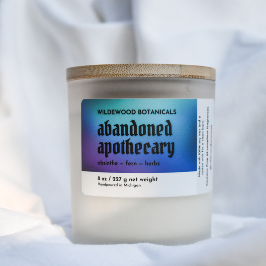 Candle jar with 'Abandoned Apothecary' label on a white background