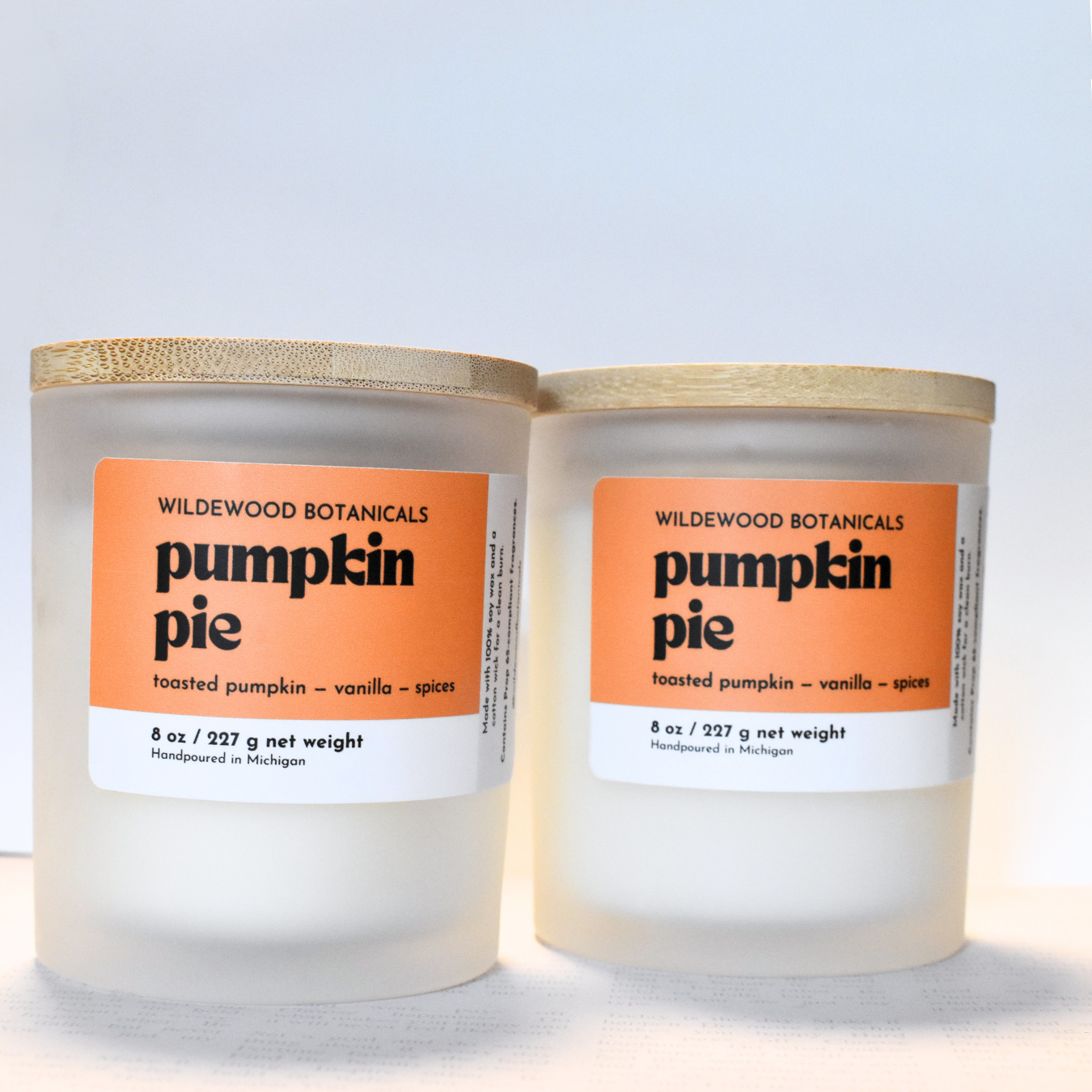 Two Wildewood Botanicals pumpkin pie candles on a light gray background
