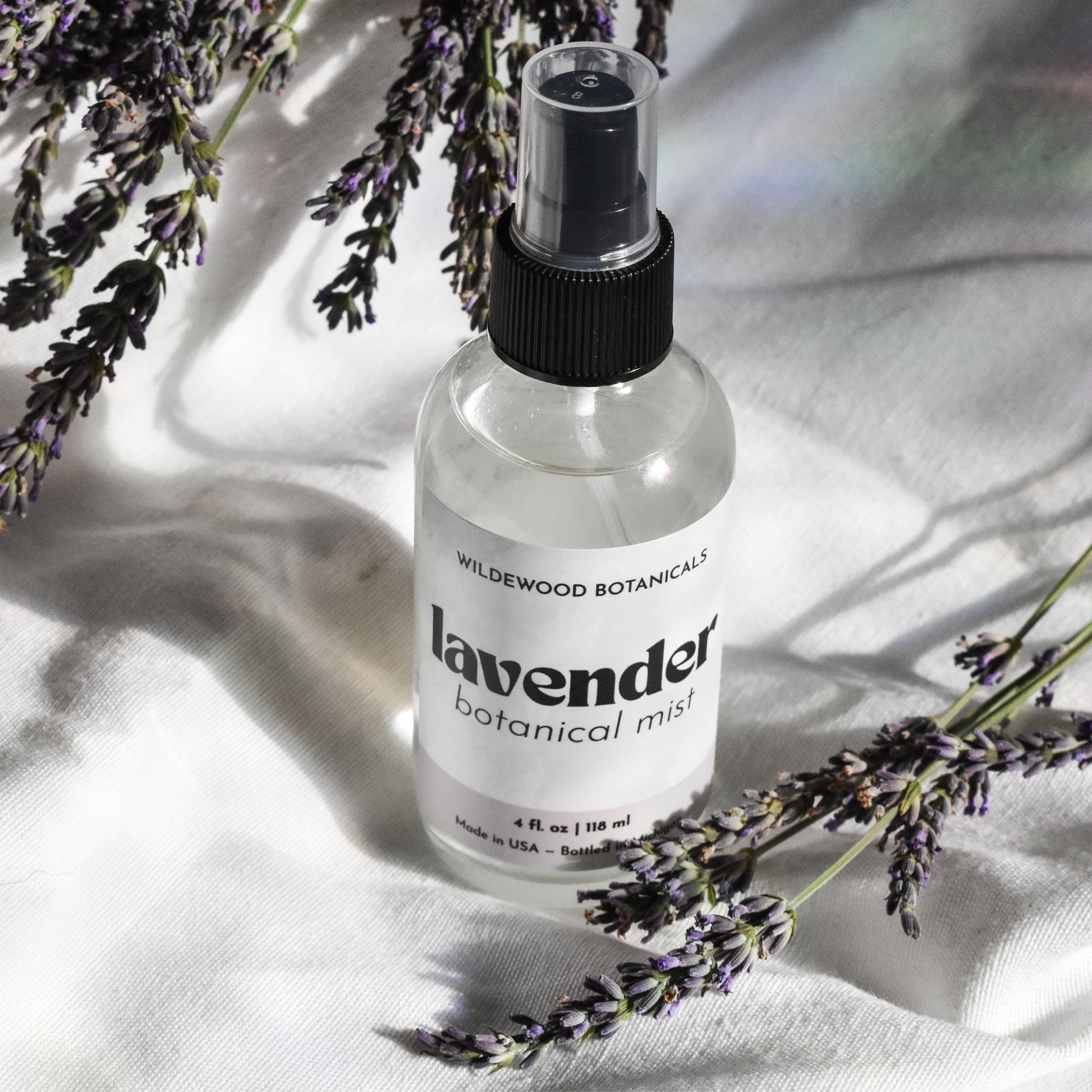 Honeyed Lavender Botanical Mist - 4 oz. on white background with lavender